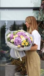 A bright mix of purple hydrangeas and peony-shaped roses, Peony Bubbles